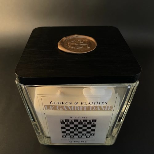 Bougie artisanale premium en verre carré avec couvercle noir. Une création G-HOME inspirée de l’ouverture Le Gambit Dame aux échecs.